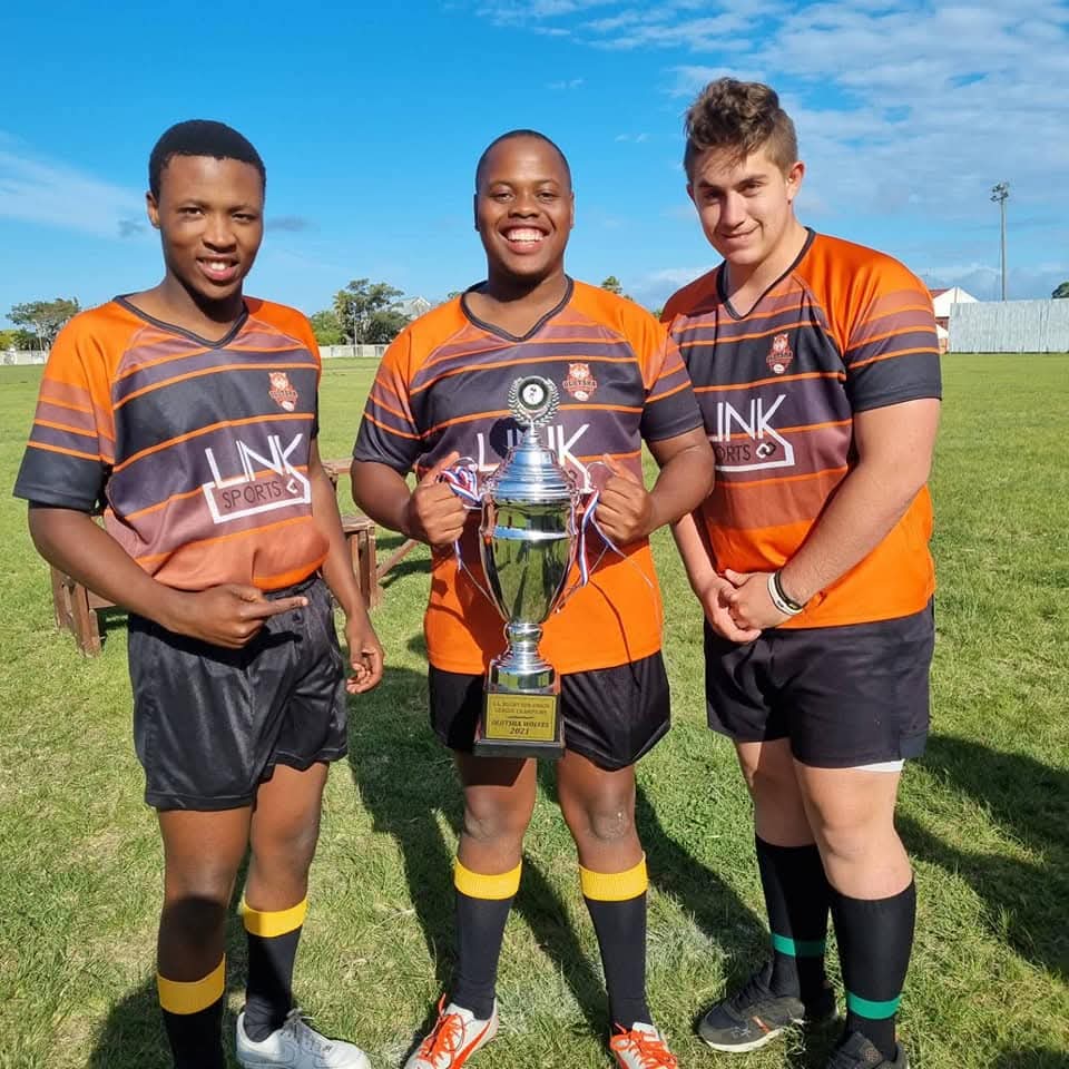 Three Olutsha Wolves players holding the 2021 league championship trophy